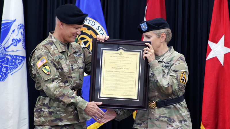 Lt. Gen. Robert M. Collins presents the Charter for PEO STRI to Brig. Gen. Christine E. Beeler,